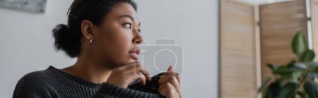 Frustrated multiracial woman with depression looking away at home, banner 