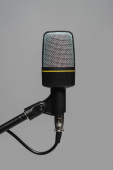 Close up view of microphone with black wire on metal stand isolated on grey, studio photo  puzzle #653053186