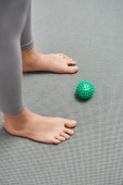 Top view of manual massage ball near barefoot woman standing on fitness mat at home, body relaxation and holistic wellness practices, balancing energy Mouse Pad 661660344