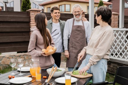 Photo for Celebration of parents day concept, family photo, excited and happy siblings near middle aged mom and dad, grill party, standing on backyard of summer house, bbq preparations - Royalty Free Image
