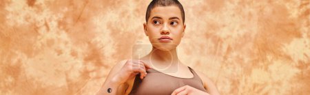 Photo for Body positivity movement, curvy and tattooed woman in crop top posing on mottled beige background, looking away, representation of body, different body shapes, generation z, youth, banner - Royalty Free Image
