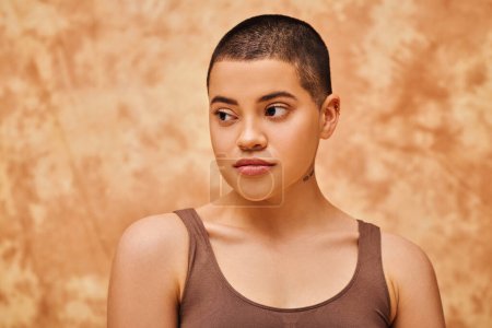 Photo for Natural beauty, young woman with short hair posing on mottled beige background, individuality, modern generation z, beauty and confidence, body positivity movement, tattooed - Royalty Free Image