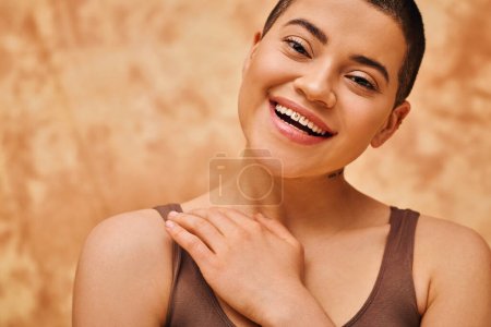 Photo for Natural look, self-acceptance, young woman with short hair posing on mottled beige background, individuality, modern generation z, beauty and confidence, body positivity movement, tattooed - Royalty Free Image