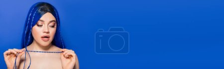 Photo for Vibrant youth, self expression, emotional, portrait of young woman with dyed hair posing on blue background, hair color, individualism, female model with makeup and trendy hairstyle, banner - Royalty Free Image
