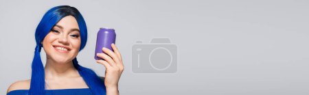 summer concept, joyful young woman with blue hair holding soda can on grey background, modern subculture, individualism, youth and lifestyle, vibrant color, self expression, unique identity, banner 