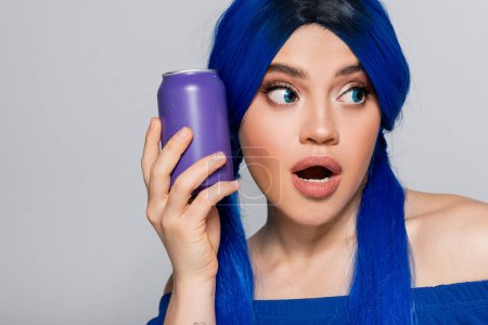 self expression, summer style, surprised young woman with blue hair holding soda can on grey background, modern subculture, individualism, youth and lifestyle, vibrant color, unique identity 