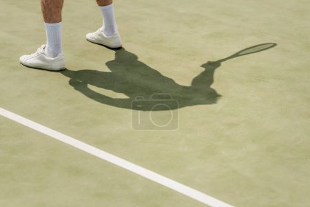 cropped view of man in white tennis shoes and socks on court, sport and leisure, summer, hobby