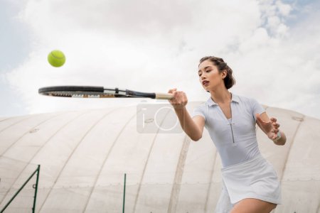 beautiful woman playing tennis, forehand, tennis racket and ball, motivation and sport