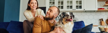 Smiling woman spending time with boyfriend and border collie near coffee and popcorn at home,banner