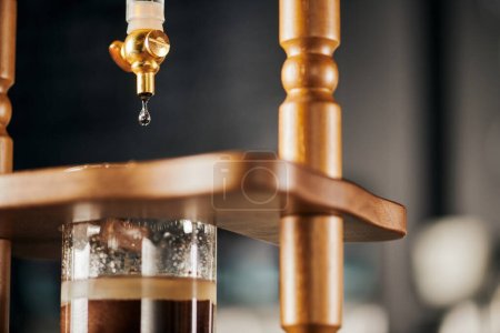 Photo for Coffee shop, cold drip brewing espresso, fresh water dripping on ground coffee, close up view - Royalty Free Image