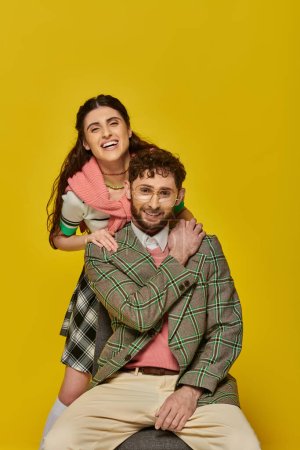 Photo for Happy students, cheerful man and woman on yellow backdrop, looking at camera, college outfits - Royalty Free Image