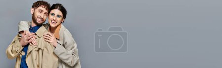 fall season, smile, romantic couple hugging on grey background, trench coats, style, romance, banner