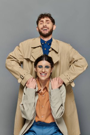 positive couple, outerwear, fall season, grey background, man and woman in trench coats, style