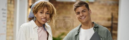 happy young man smiling next to african american woman in braces, coworking, startup, team, banner