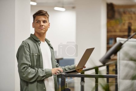 young businessman using laptop, coworking, modern office, generation z, startup, planning project