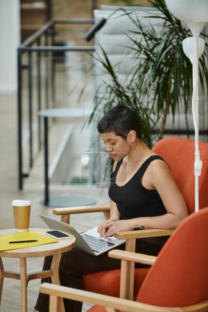young businesswoman using laptop, coworking, startup culture, gen z, smartphone, coffee to go