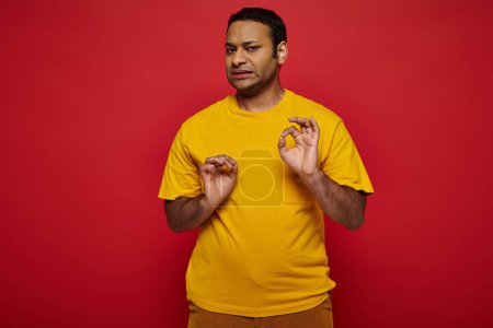 Photo for Emotional indian man in bright casual clothes making disgusted expression on red background - Royalty Free Image