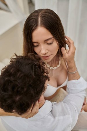 Photo for Top view of man stroking hair of tender woman with closed eyes and spending time together - Royalty Free Image