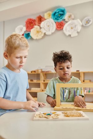 montessori concept, multicultural boys playing with color bead stairs, learn through play, kids