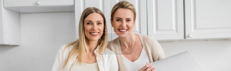 Photo for Two attractive blonde sisters smiling sincerely and looking at camera, family bonding, banner - Royalty Free Image