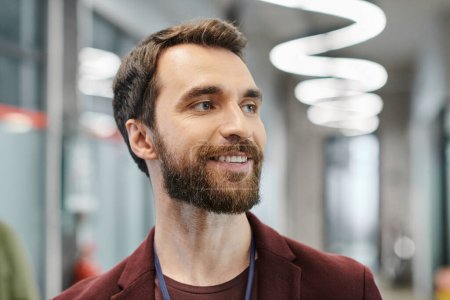 Photo for Portrait of cheerful bearded entrepreneur looking away in modern office, business success - Royalty Free Image