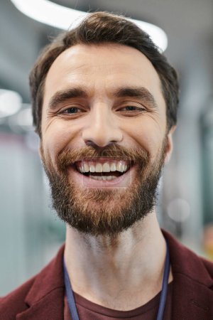 Photo for Portrait of excited bearded businessman with radiant smile looking at camera in contemporary office - Royalty Free Image