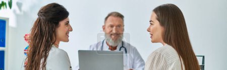 cheerful lgbt couple at doctor's office smiling with doctor on blurred backdrop, ivf concept, banner