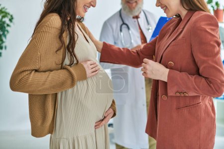 cropped view of doctor standing next to pregnant lesbian woman with her partner, ivf concept