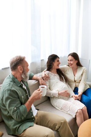 father paid visit to his lesbian daughter and her partner, talking and sitting on sofa, ivf concept