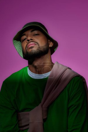 Photo for Young bearded african american man in green sweatshirt with diamond earring, fashion concept - Royalty Free Image
