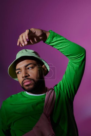 Photo for Young bearded male model in stylish casual attire posing on purple backdrop, fashion concept - Royalty Free Image
