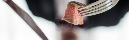 Photo for Close up shot of medium cooked delicious beef steak and silver knife and fork, gourmet meal banner - Royalty Free Image