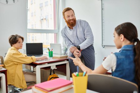 Photo for A man stands before a desk, passionately teaching children in a vibrant classroom setting. - Royalty Free Image