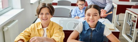 Photo for Happy group of students at a table in a bright, bustling classroom. - Royalty Free Image