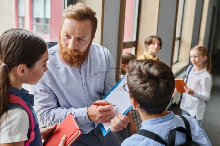 A bearded man teacher engages a group of children in a lively classroom, imparting knowledge and wisdom through storytelling.