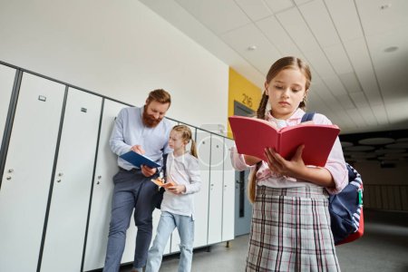Photo for Students and their teacher are gathered by the lockers in the hallway, engaging in a lively discussion. - Royalty Free Image