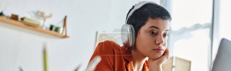 Photo for Focused short haired woman holding pen and looking attentively at her laptop, studying, banner - Royalty Free Image