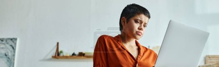 Photo for Focused serious woman looking attentively at her laptop during online lesson, studying, banner - Royalty Free Image