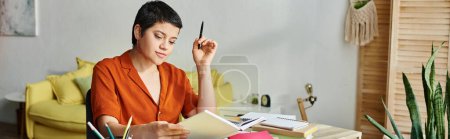 cheerful short haired woman in casual outfit studying at desk and looking at book, education, banner