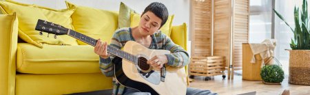 focused young woman with guitar sitting on floor at online music lesson, education at home, banner