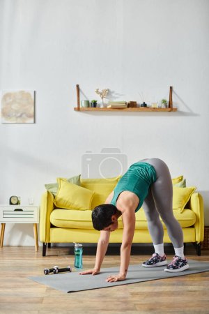 vertical shot of good looking athletic woman in sportswear exercising actively, fitness and sport