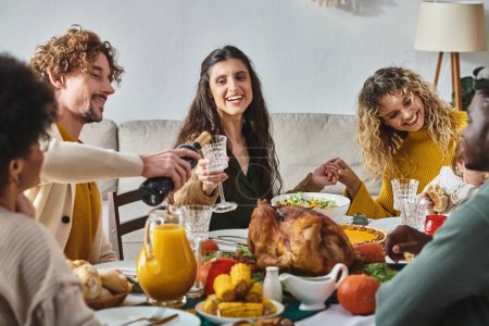 Thanksgiving celebration, happy interracial family and friends gathering near turkey, lgbt couple