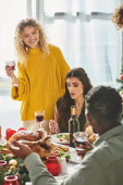 happy lgbt couple surrounded by their multiethnic relatives enjoying wine and food, Christmas Stickers #678871510
