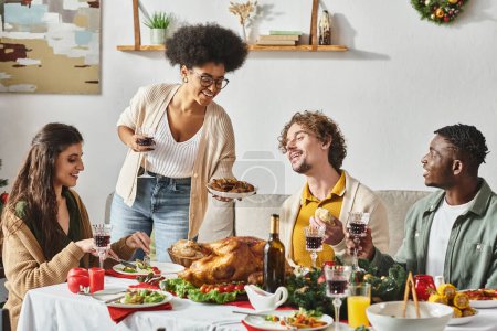 joyous multiracial relatives enjoying their delicious festive feast with wine and turkey, Christmas