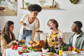 joyous multiracial relatives enjoying their delicious festive feast with wine and turkey, Christmas Poster #678871882