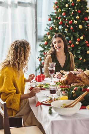 happy lgbt couple at family gathering looking and smiling cheerfully at each other, Christmas