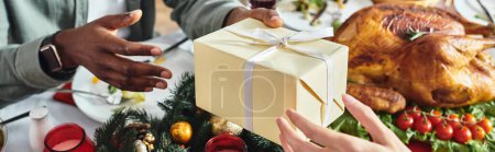 Photo for Cropped view of young african american man receiving Christmas gift from his relative, banner - Royalty Free Image