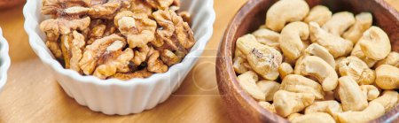 top view of high-calorie cashews and walnuts in bowls on table, plants-based diets concept, banner