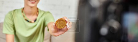 Photo for Cropped view of smiling woman with plant-based cutlet, vegetarian video blog, horizontal banner - Royalty Free Image