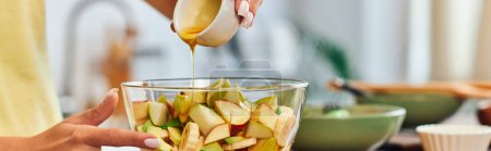 cropped view of vegetarian woman pouring honey in glass bowl with delicious fruit salad, banner